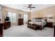 Serene main bedroom with a ceiling fan, carpeted floors, and an abundance of natural light at 4217 E Edgemont Ave, Phoenix, AZ 85008