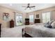 Inviting main bedroom with a ceiling fan, patio access, and a full view of the backyard at 4217 E Edgemont Ave, Phoenix, AZ 85008