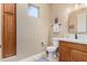 Cozy powder room features a storage cabinet, vanity with sink, and neutral color palette at 4217 E Edgemont Ave, Phoenix, AZ 85008