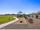 Playground and common area with walking paths, benches, and corn hole game surrounded by neighborhood homes at 4354 W Jeanette Ln, San Tan Valley, AZ 85144