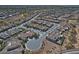 Wide aerial view of a Sun City Anthem neighborhood with a golf course and neatly arranged single-Gathering homes at 4424 N Potomac Dr, Florence, AZ 85132