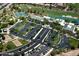 Aerial view of a community showcasing tennis courts, a pool, and lush landscaping at 4424 N Potomac Dr, Florence, AZ 85132