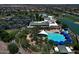 Aerial view of community buildings with a pool, palm trees and well-maintained landscaping at 4424 N Potomac Dr, Florence, AZ 85132