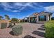 Well-maintained backyard featuring desert landscaping, a covered patio, and mature shrubbery at 4424 N Potomac Dr, Florence, AZ 85132