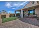 Outdoor space with a covered patio, turfed lawn, and seating, ideal for relaxation and entertainment at 4424 N Potomac Dr, Florence, AZ 85132