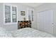 Well-lit bedroom featuring plantation shutters and unique decorative chest at 4424 N Potomac Dr, Florence, AZ 85132