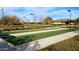 Bocce ball courts surrounded by lush landscaping and shaded benches for players at 4424 N Potomac Dr, Florence, AZ 85132