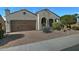 Charming single-story home with a desert landscape, arched entryway, and a two car garage at 4424 N Potomac Dr, Florence, AZ 85132