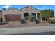 Charming single-story home featuring a well-manicured front yard and a two-car garage at 4424 N Potomac Dr, Florence, AZ 85132