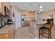 Kitchen featuring a granite island, stainless steel appliances, and tile backsplash at 4424 N Potomac Dr, Florence, AZ 85132