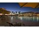 Inviting outdoor pool area at dusk with lounge chairs, shade structures, and palm trees at 4424 N Potomac Dr, Florence, AZ 85132