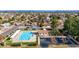 Aerial perspective of a community pool with clubhouse, parking area and manicured landscaping at 4606 W Continental Dr, Glendale, AZ 85308