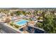 Aerial shot of community pool with lounge area, a clubhouse, and parking, surrounded by lush landscaping at 4606 W Continental Dr, Glendale, AZ 85308