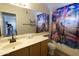 Bathroom featuring a sink with cabinet, large mirror, and themed shower curtain at 4606 W Continental Dr, Glendale, AZ 85308