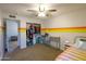 Comfortable bedroom with a retro rainbow stripe, ceiling fan, and organized closet at 4606 W Continental Dr, Glendale, AZ 85308