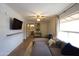 Living room with large sectional, TV, and views into bathroom and bedroom at 4606 W Continental Dr, Glendale, AZ 85308