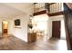 Open living space with wood flooring, a loft and a view of the front entry and dining area at 4606 W Continental Dr, Glendale, AZ 85308