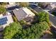 Aerial view of a home with tile roof, solar panels, and large covered patio surrounded by mature trees at 4741 W Kristal Way --, Glendale, AZ 85308