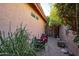 Cozy side yard with gravel and stone, potted plants, and outdoor seating at 4741 W Kristal Way --, Glendale, AZ 85308