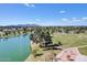 Scenic aerial view of a park with lake, grassy areas, and trees under a blue sky at 5094 N 83Rd St, Scottsdale, AZ 85250