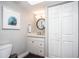 Bathroom features a white vanity, round mirror, updated fixtures and a closet at 5094 N 83Rd St, Scottsdale, AZ 85250