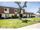 Well-maintained townhome exterior with fresh green lawn and mature tree at 5094 N 83Rd St, Scottsdale, AZ 85250