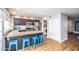 Kitchen featuring a breakfast bar with blue stools, stainless steel appliances, and ample counter space at 5094 N 83Rd St, Scottsdale, AZ 85250