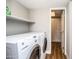 Bright laundry room includes washer, dryer, storage shelf, and wood-look floors at 5094 N 83Rd St, Scottsdale, AZ 85250