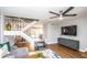 Open-concept living room with modern decor, a staircase, and a television mounted on the wall at 5094 N 83Rd St, Scottsdale, AZ 85250