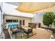 Outdoor patio with a bar, hot tub, seating area, and shaded awning at 5094 N 83Rd St, Scottsdale, AZ 85250