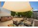 Outdoor patio with a hot tub and seating area under a shaded awning at 5094 N 83Rd St, Scottsdale, AZ 85250