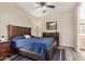 Comfortable bedroom with ceiling fan, wood-look flooring, dresser, and warm ambiance at 5303 N 7Th St # 114, Phoenix, AZ 85014