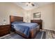 Relaxing bedroom with a wood-framed bed, ample lighting, and wood-look flooring at 5303 N 7Th St # 114, Phoenix, AZ 85014