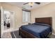 Comfortable bedroom with a wooden bed frame, ceiling fan, and view to other rooms at 5303 N 7Th St # 114, Phoenix, AZ 85014