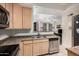 Well-lit kitchen with light wood cabinets and stainless steel appliances at 5303 N 7Th St # 114, Phoenix, AZ 85014