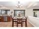 Cozy dining room features modern lighting, a view of the backyard pool, and easy access to the kitchen at 5331 N Pajaro Ct, Litchfield Park, AZ 85340