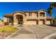 Charming two-story home featuring a three-car garage, landscaped front yard, and a welcoming arched entryway at 5331 N Pajaro Ct, Litchfield Park, AZ 85340