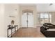 Welcoming foyer with neutral paint, tiled floors, and a decorative transom window above the double-door entry at 5331 N Pajaro Ct, Litchfield Park, AZ 85340