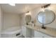 Well-lit bathroom featuring double sinks, granite countertops, and a large tub at 53974 W Barrel Rd, Maricopa, AZ 85139