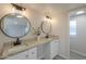 Bathroom vanity featuring granite counters, dual sinks, and modern round mirrors at 53974 W Barrel Rd, Maricopa, AZ 85139