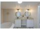 Contemporary bathroom featuring a soaking tub, granite countertops, and dual sinks at 53974 W Barrel Rd, Maricopa, AZ 85139