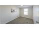 Bedroom with neutral paint, carpeted floors, and a window at 53974 W Barrel Rd, Maricopa, AZ 85139