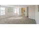 Light-filled bedroom featuring carpet, two windows, and an en-suite bathroom at 53974 W Barrel Rd, Maricopa, AZ 85139