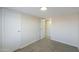 Bedroom with neutral paint, carpeted floors, and two entryways at 53974 W Barrel Rd, Maricopa, AZ 85139