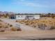 Exterior of single-story home with desert landscaping and fenced perimeter at 53974 W Barrel Rd, Maricopa, AZ 85139