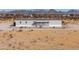 View of single-story home with a porch, fenced yard, and desert landscaping at 53974 W Barrel Rd, Maricopa, AZ 85139