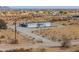 Exterior of single-story home featuring a fenced yard and desert landscaping at 53974 W Barrel Rd, Maricopa, AZ 85139