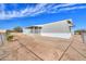 Exterior view of a single-story home featuring a porch, fencing, and desert landscaping at 53974 W Barrel Rd, Maricopa, AZ 85139