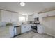 Bright white kitchen boasts granite counters, stainless appliances, and ample cabinet space at 53974 W Barrel Rd, Maricopa, AZ 85139