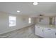 Spacious living room showcases neutral paint, wood-look floors and natural light at 53974 W Barrel Rd, Maricopa, AZ 85139